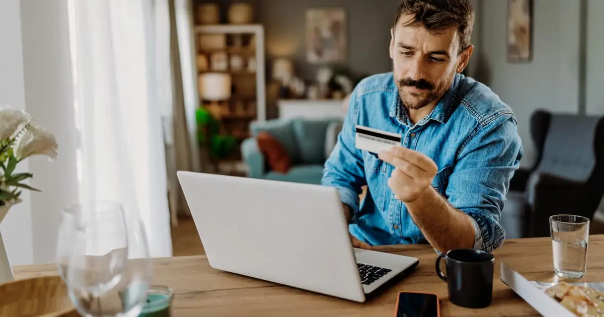I want to pay off $20,000 of credit-card debt in one year. Should I hire someone to negotiate my bill?
