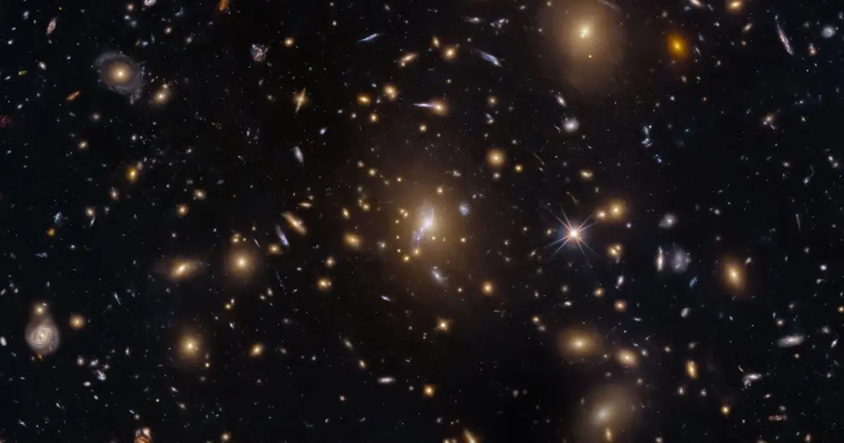 Hubble captures galaxy swarm with lensed arcs from early universe